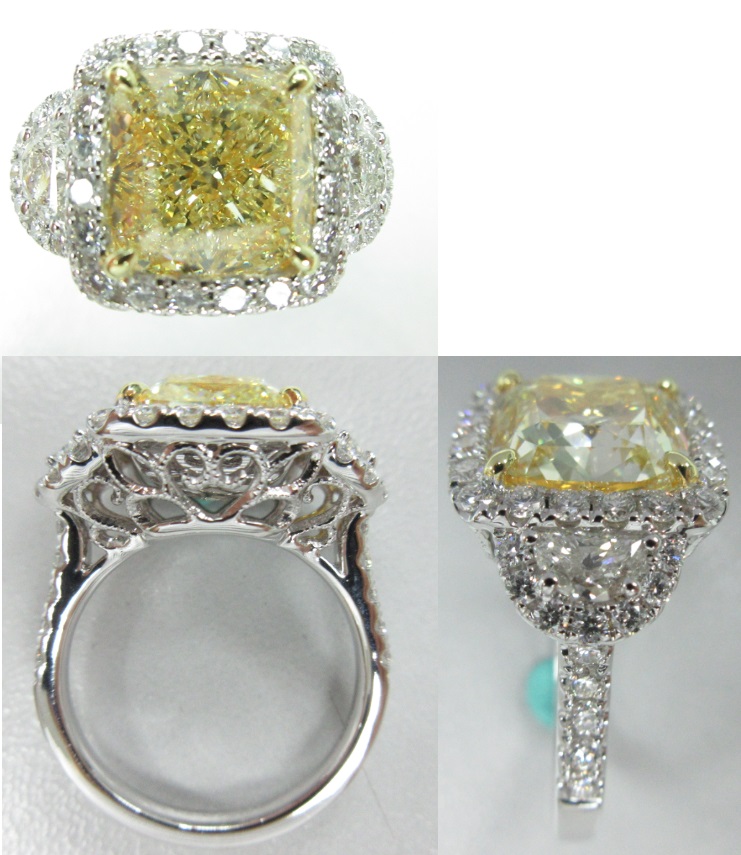 Rings 18k WG Center Stone: Diamond Cushion 5.18ct FY side 2 stones 0.47 ct, 44 stones 0.87ct.